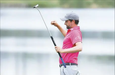  ?? Richard Heathcote/Getty Images ?? Webb Simpson celebrates after winning The Players Championsh­ip Sunday by four shots. Simpson built a seven-shot lead entering the final day after three impressive rounds that included tying the course record Friday with a 63.