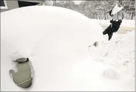  ?? TONY DEJAK — THE ASSOCIATED PRESS ?? Raid H digs his car out in Erie, Pa. The cold weather pattern was expected to continue through the holiday weekend, according to the National Weather Service.