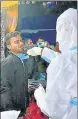  ?? ?? A healthcare worker collects a nasal swab sample of a vendor in Tezpur, Assam.