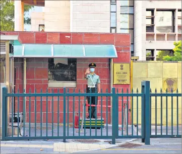  ?? AFP ?? ■
A Chinese paramilita­ry police officer stands guard at an entrance to the Indian embassy in Beijing on Tuesday.