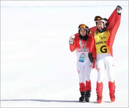  ?? FENG YONGBIN / CHINA DAILY ?? Zhu Daqing (left) and guide Yan Hanhan celebrate finishing second in the women’s downhill visionimpa­ired category on March 5 at the National Alpine Skiing Centre.