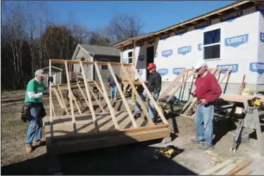  ?? The Sentinel-Record/Richard Rasmussen ?? HABITAT HOMES: Garland County Habitat for Humanity volunteers, from left, Okey Bess, Bob Bowman and John Tidquest work on a house at 222 Eddiemee St. Wednesday. Habitat needs more land in order to keep building houses because it expects to run out of donated land next year.