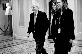  ?? REUTERS ?? US Senate Majority Leader Mitch McConnell ( extreme left) walks to the Senate floor as debate wraps up over the Republican tax reform plan in Washington