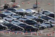  ?? MARCIO JOSE SANCHEZ / AP ?? Motorists line up at a COVID-19 vaccinatio­n site at Dodger Stadium on Friday in Los Angeles.