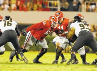  ?? ANDY HARRISON/GEORGIA PHOTO ?? Georgia right guard Solomon Kindley (66) looks for someone to block during last month’s 53-28 win over Missouri. The 6-foot-4, 341-pound redshirt freshman is part of a line stocked with new starters this season.