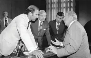  ?? The Associated Press ?? In this July 13, 1982, file photo, Secretary of State designate George Shultz, right, speaks with members of the Senate Foreign Relations Committee prior to the start of the afternoon session of the panel on Capitol Hill in Washington. From left, Sen. Joseph Biden, D-Del., chairman of the panel Sen. Charles Percy, R-Ill., and Sen. Edward Zorinsky, D-Neb.