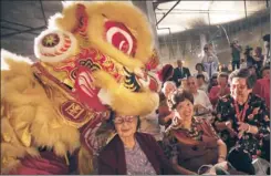  ?? Michael Robinson Chavez Los Angeles Times ?? RESIDENTS SMILE as a traditiona­l Chinese lion dance is performed at a news conference at Wal-Mart’s planned Chinatown location this week.