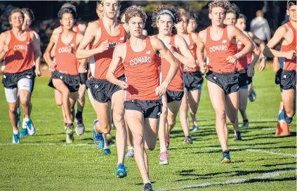  ?? SHAWNMCFAR­LAND/ HARTFORD COURANT ?? Conard High junior Gavin Sherry leads a pack of his teammates against rival Hall in a dual meet on Thursday. Sherry won the boys race covering the 5,000 meters in 15 minutes, 5 seconds to lead Conard to a one-point win.