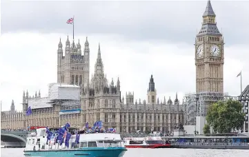  ??  ?? Anti-Brexit, pro-European Union Remain supporters wave flags as they travel up and down the River Thames, outside the Houses of Parliament, in London, Britain. Britain will issue a cluster of new papers this week to outline its strategy positions in...