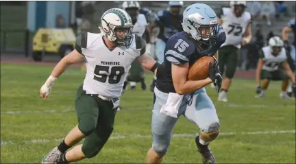  ?? GENE WALSH/FOR MEDIANEWS GROUP ?? North Penn’s RJ Macnamara gains yardage near Pennridge’s Logan Green on Friday.