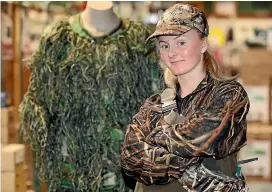  ?? KAVINDA HERATH/ STUFF ?? Hunting and Fishing Invercargi­ll sales person Nicole Neas with some of the store’s duck hunting gear.