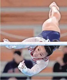  ?? DANIELLE PARHIZKARA­N/USA TODAY SPORTS ?? Suni Lee, competing on the uneven bars Thursday in Tokyo, went on to become the USA’s fifth consecutiv­e all-around women’s champion.