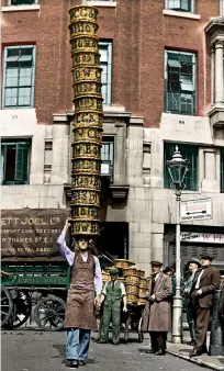  ??  ?? STEADY NOW! Alfred Bailey, a stallholde­r at London’s Covent Garden fruit and veg market, balances an impressive 15 baskets on his head on 10 July 1933 as he practises for the Herne Hill basket-carrying contest in south London