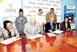  ?? CONTRIBUTE­D ?? Minister of Education and Youth Fayval Williams (seated, second right) and Minister of Justice Delroy Chuck (seated, second left) sign a memorandum of understand­ing (MOU) for the continued delivery of restorativ­e practices training in schools across Jamaica. Observing the signing (seated, from left) are Permanent Secretary in the Ministry of Justice, Grace Ann Stewart McFarlane; and Permanent Secretary in the Ministry of Education and Youth, Dr Kasan Troupe. Also looking on (standing, from left) are Director of the Restorativ­e Justice Branch in the Ministry of Justice, Joanalee Robertson; Principal Director of the Social Justice Division in the Ministry of Justice, Jamie-Ann Chevannes; and the education ministry’s director for safety and security in schools, Richard Troupe.