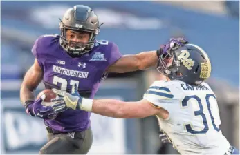  ?? WILLIAM HAUSER, USA TODAY SPORTS ?? Justin Jackson, left, has had at least 245 carries in each of his three seasons at Northweste­rn.