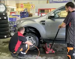  ??  ?? Matt and Chris hard at it replacing four tyres on this SUV.