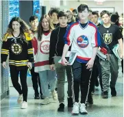  ?? GRAHAM HUGHES / THE CANADIAN PRESS ?? Students at John Rennie High School in Montreal wear jerseys Thursday in honour of the bus crash victims.