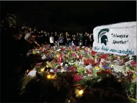  ?? AL GOLDIS — THE ASSOCIATED PRESS ?? Mourners attend a vigil at The Rock on the grounds of Michigan State University in East Lansing, Mich., on Wednesday.