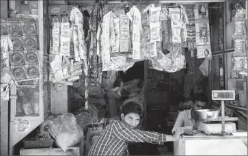  ?? Tsering Topgyal
Associated Press ?? PACKETS OF MAGGI NOODLES hang at a shop in New Delhi. Officials said they found MSG and excessive levels of lead in samples of the instant noodles. Nestle said its own lab tests showed the product was safe.