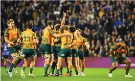  ?? Photograph: Andy Buchanan/AFP/Getty Images ?? Australia players celebrate their narrow victory over Scotland at the final whistle.