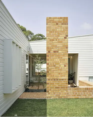  ??  ?? 05 Natural light penetrates the interiors of the new, west-facing parents’ wing via diminutive garden voids.
06 The paved outdoor room transition­s to a courtyard, bounded by a low seating edge and anchored with a fireplace.