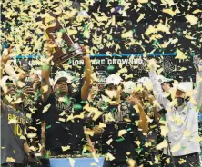  ?? Jamie Squire / Getty Images ?? Baylor forward Mark Vital hoists the NCAA championsh­ip trophy after a beatdown against Gonzaga.