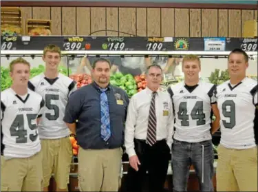  ?? Submitted photo ?? FREE GROCERIES ON THE LINE ... Pennridge Rams football players, from left, Kyle Bigam, Alex Krivda, Mackenzie Crawford and John Dubyk design a winning play for the shopping spree with Landis Markets’ Bill Delaney and Pat Kendig. Want to win free...