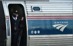  ?? (AP/Robert F. Bukaty) ?? A conductor makes sure all is clear as the Amtrak Downeaster passenger train pulls out of the station Tuesday in Freeport, Maine.
