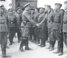  ??  ?? This 1942 photo provided by the the public prosecutor's office in Hamburg via the United States Holocaust Memorial Museum, shows Heinrich Himmler, center left, shaking hands with new guard recruits at the Trawniki concentrat­ion camp in Nazi occupied Poland. Trawniki is the same camp, where some time after this photo was made, Jakiw Palij trained and served as a guard. The White House says that Palij, a 95-year-old former Nazi concentrat­ion camp guard has been deported to Germany, 14 years after a judge ordered his expulsion. In a statement, the White House said the deportatio­n of Palij, who lived in New York City, was carried out early yesterday