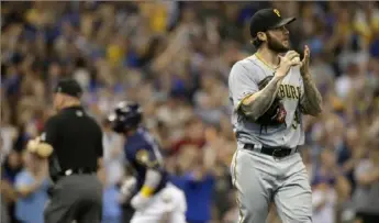  ?? Associated Press ?? Pirates starter Trevor Williams reacts after giving up a home run to Milwaukee’s Orlando Arcia, in back, in the second inning.