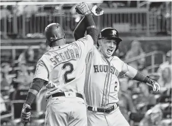  ?? Rob Carr / Getty Images ?? Astros third baseman Alex Bregman, right, celebrates with All-Star teammate Jean Segura of the Mariners after homering in the 10th inning. Segura earlier hit a three-run homer in the eighth.