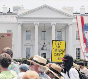  ?? Alex Brandon / Associated Press ?? Activists march past the White House to protest the Trump administra­tion’s approach to separation of children from immigrant parents on Saturday in Washington.