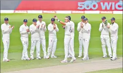  ?? AP ?? England players congratula­te Stuart Broad for taking 500 wickets in Tests. n