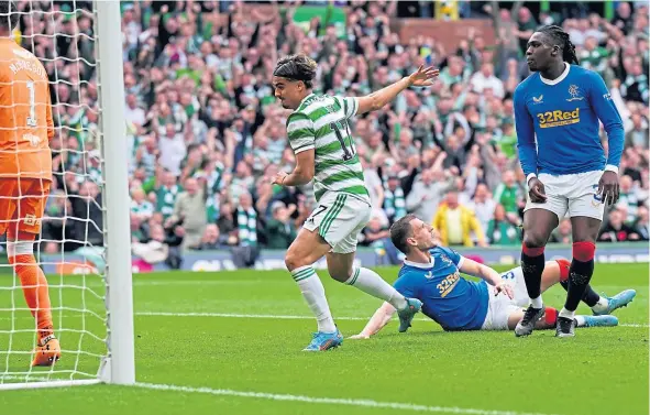  ?? ?? Jota nips in ahead of Borna Barisic to put Celtic in front, before Fashion Sakala lashed in an equaliser for Rangers.