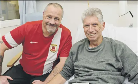  ??  ?? FIRM FRIENDS Pompey fan Chris Scovell (right) meets Steve Sedgewick at Queen Alexandra Hospital after Steve saved his life by administer­ing CPR after he collapsed from a heart attack in Portsmouth. Below, Steve with his award