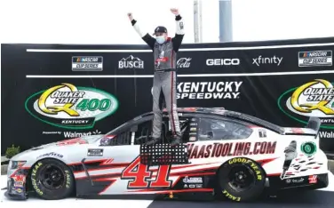  ?? AP PHOTOS/MARK HUMPHREY ?? Cole Custer celebrates after winning Sunday’s NASCAR Cup Series race at Kentucky Speedway in Sparta, Ky.