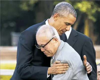  ?? Jim Watson/AFP/Getty Images ?? President Barack Obama hugs Shigeaki Mori, a survivor of the 1945 atomic bombing of Hiroshima, during a visit Friday to the Hiroshima Peace Memorial Park. Mr. Obama paid a moving tribute to victims of the world's first nuclear attack.