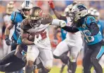  ?? MIKE MCCARN /ASSOCIATED PRESS ?? Tampa Bay’s Peyton Barber (25) runs for a touchdown in front of Carolina cornerback Donte Jackson, right, on Thursday night in Charlotte, N.C.