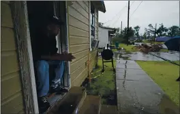  ?? GERALD HERBERT — THE ASSOCIATED PRESS ?? Ernest Jack, whose home was severely damaged from Hurricane Laura, sits in his front doorway as he waits for the arrival of Hurricane Delta in Lake Charles, La.