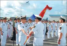  ?? PROVIDED TO CHINA DAILY ?? Vice-Admiral Shen Jinlong, commander of the PLA Navy, presents a flag to the Djibouti Logistics Support Base garrison at their departure ceremony at a naval port in Zhanjiang, Guangdong province, on Wednesday.