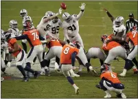  ?? JACK DEMPSEY — THE ASSOCIATED PRESS ?? The Raiders block a field goal attempt by Denver Broncos kicker Brandon McManus during the first half Sunday in Denver.