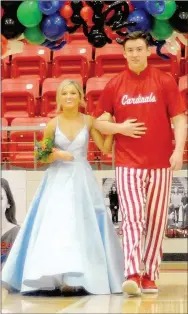  ??  ?? Junior maid Keely Stout, daughter of Jason Stout and Brandi Moore, escorted by Austin Shelley, son of John and Melissa Shelley.