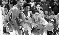  ?? JAMES CRISP/AP ?? Kentucky’s Ashton Hagans is sandwiched between Florida’s Andrew Nembhard (2) and Kerry Blackshear Jr. during a Feb. 22 game.