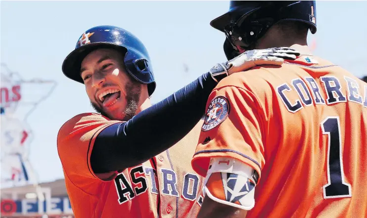  ?? — AP ?? George Springer, left, of the Astros celebrates his solo shot in the fifth inning against the Twins with teammate Carlos Correa. Springer hit two home runs in the game.