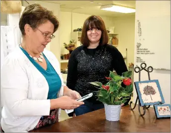  ?? TIMES photograph by Annette Beard ?? Mechel Wall and India Carlson offer bridal consulting and flower arrangemen­ts in The Cottage Flower Shop.