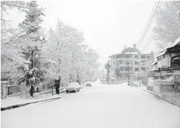  ?? SANA ?? Snow covers a street Wednesday in Slanfah, a town in western Syria. Snow blocked roads, disrupted traffic and delayed COVID-19 vaccinatio­n campaigns across the Mideast.