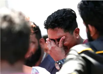  ?? — Reuters photo ?? A relative of a victim of the explosion at St. Anthony’s Shrine, Kochchikad­e church reacts at the police mortuary in Colombo.