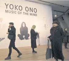  ?? ?? Visitors walk past a poster during a photocall to promote the forthcomin­g exhibition ‘Yoko Ono: Music of the Mind’ at Tate Modern in London.