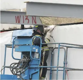  ?? PHOTOS: IAN KUCERAK ?? A welder joins shipping containers at Westgate Manor on Thursday.