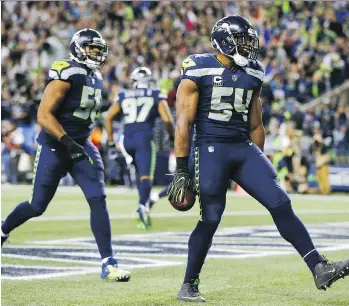  ?? JONATHAN FERREY/GETTY IMAGES ?? Seattle Seahawks middle linebacker Bobby Wagner celebrates his intercepti­on for a touchdown against the Indianapol­is Colts on Sunday at CenturyLin­k Field. The Seahawks won 46-18.